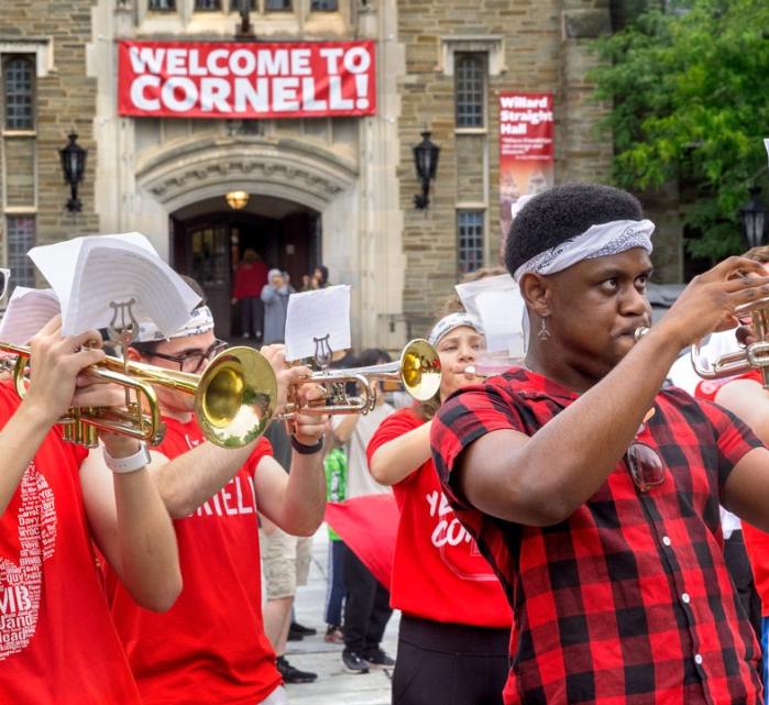students in red shirts playing musical instruments outside