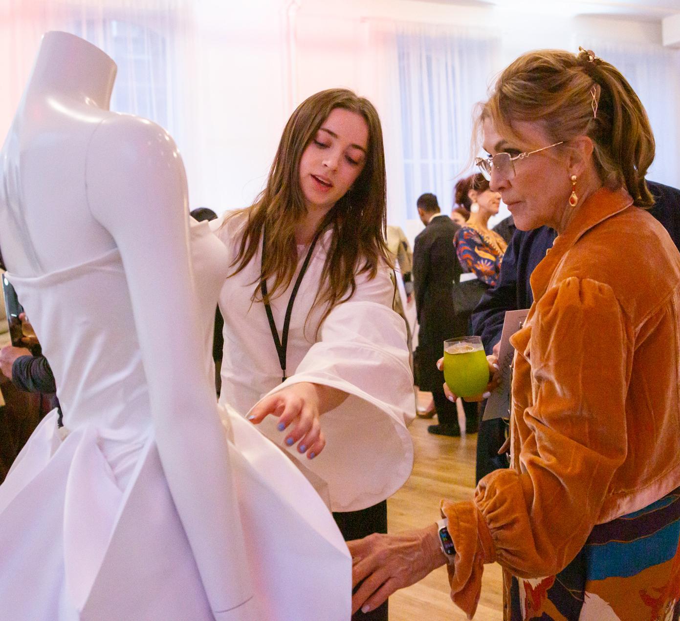 Margaret Watkins ’27 explains how her prism dress unfurls to reveal a full skirt.