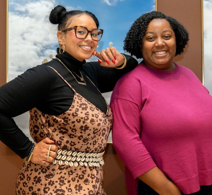three people smiling at the camera
