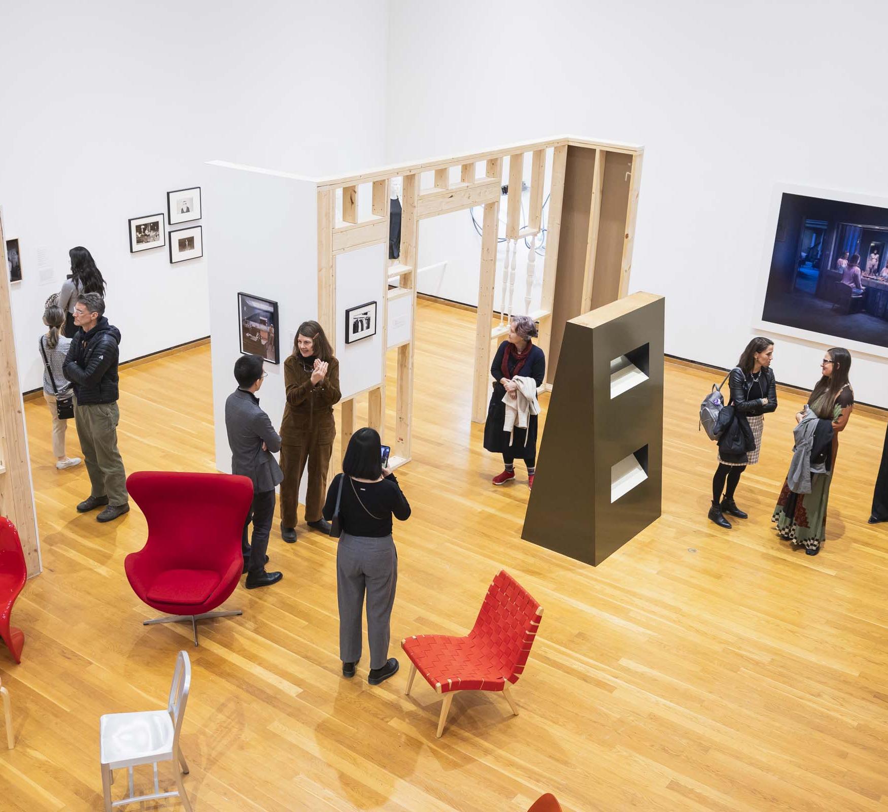 overview of a museum exhibit with people looking at art