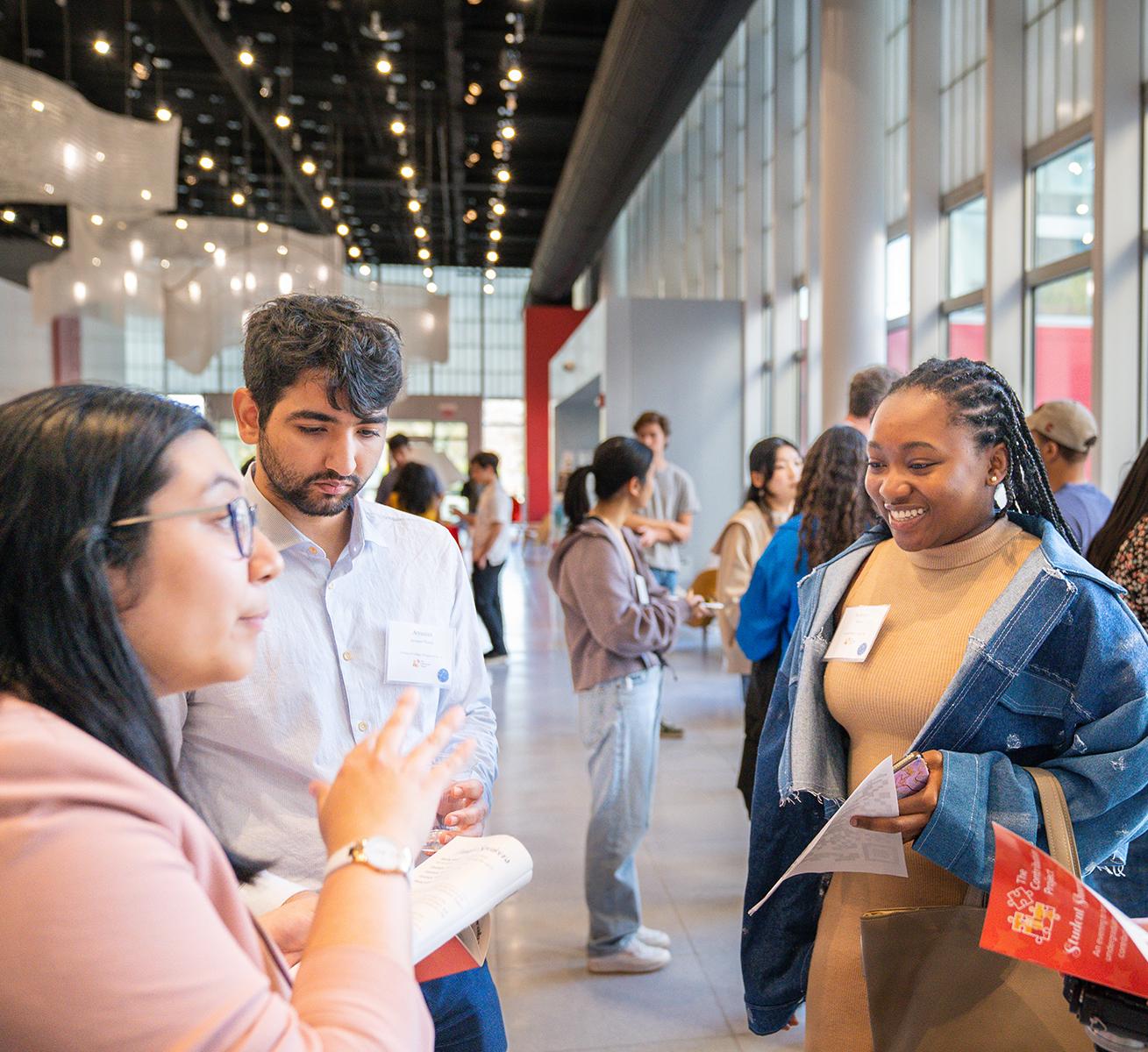 Students converse at the Cornell Human Ecology Contribution Project Student Showcase