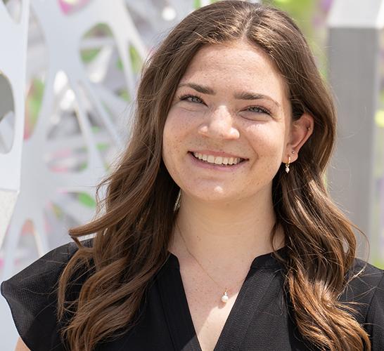 Rebecca Gordon wearing a black blouse and smiling outside.