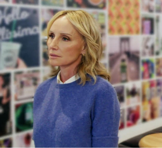 two people standing in front of a board of photos