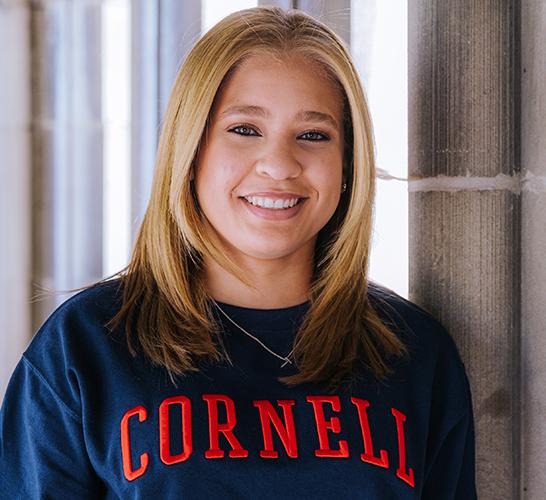 Thais Salas smiling and wearing a Cornell sweatshirt.