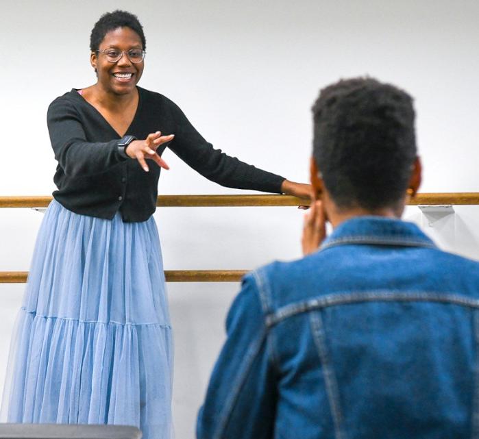 Carly Robinson directs students in the ensemble