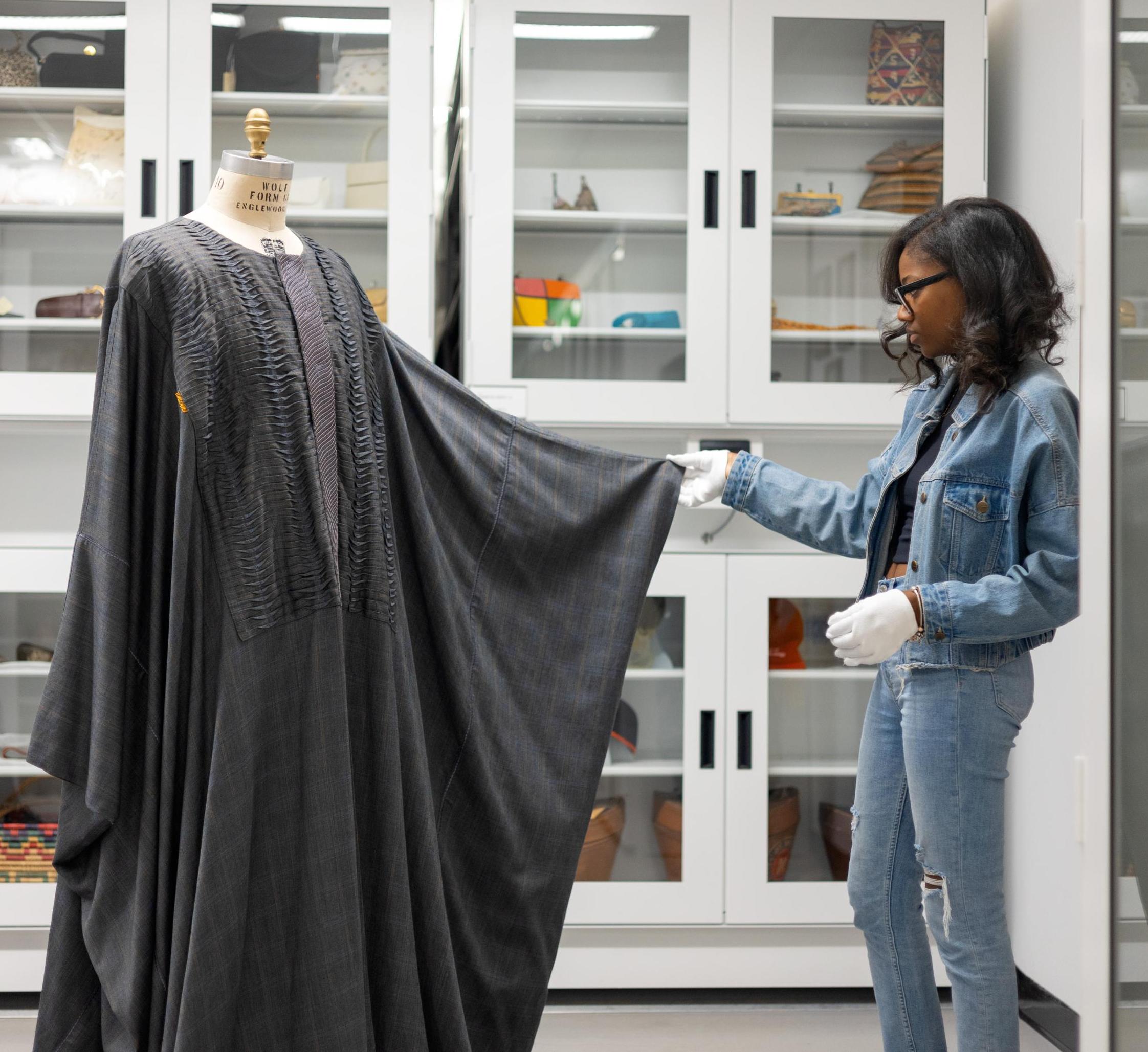 Graduate student Dyese Matthews inspects caftan