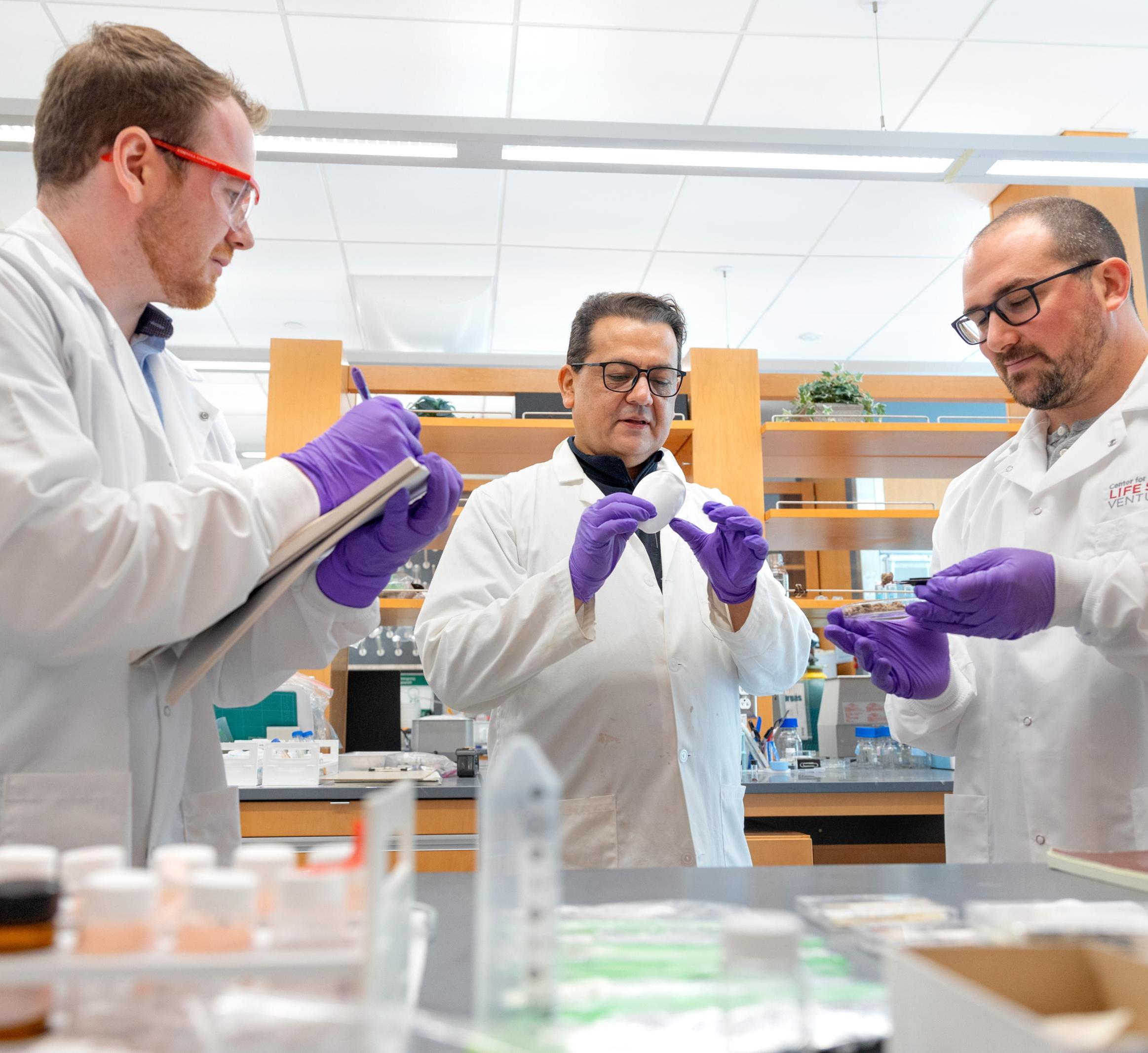 Prof. Juan Hinestroza (center) works with members from RETRN bio on sustainable food packaging