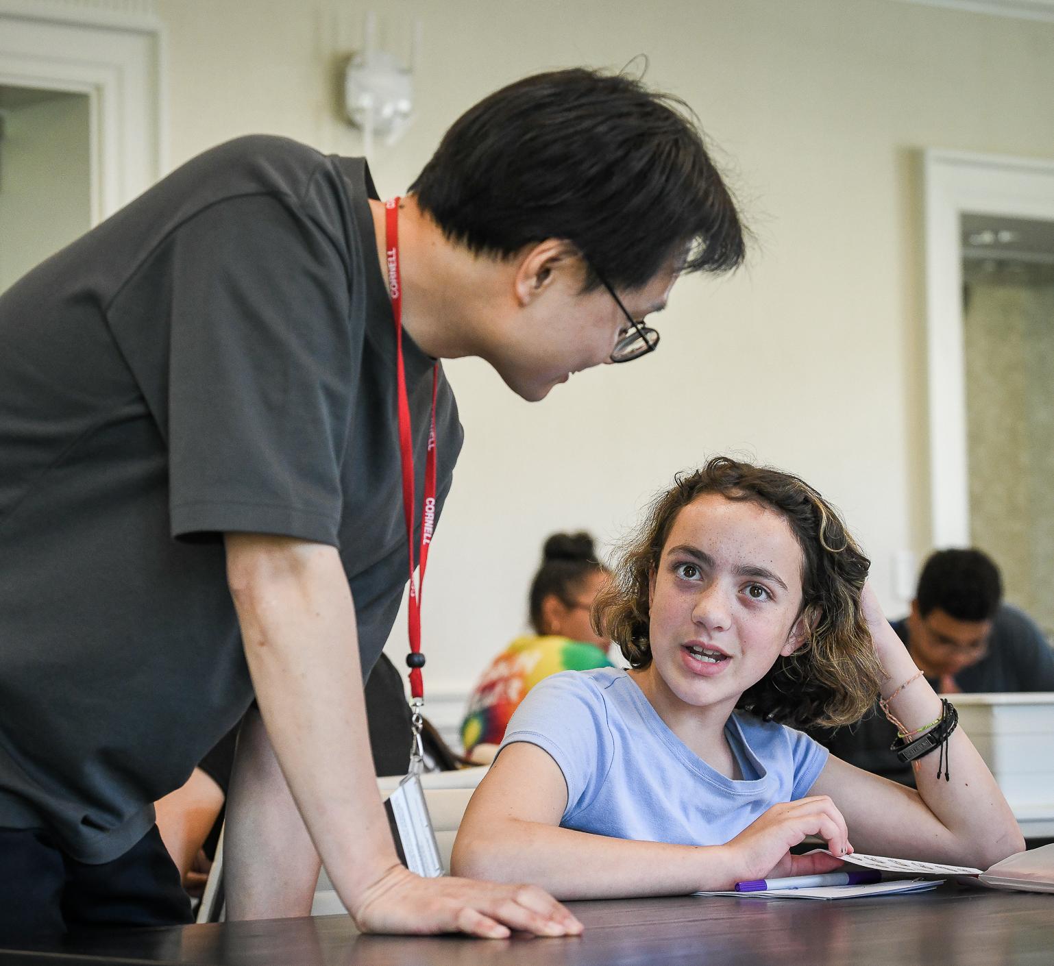 Prof. Jay Yoon speaks to a middle school student during a workshop