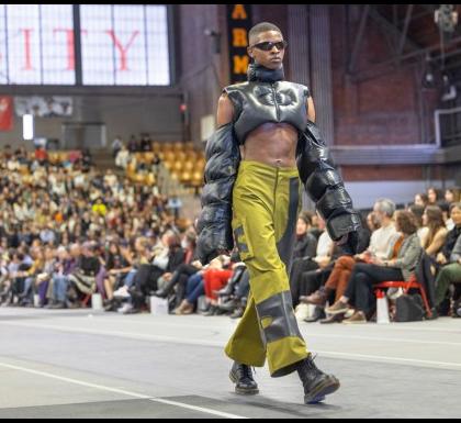 a model walks down the runway in Barton Hall