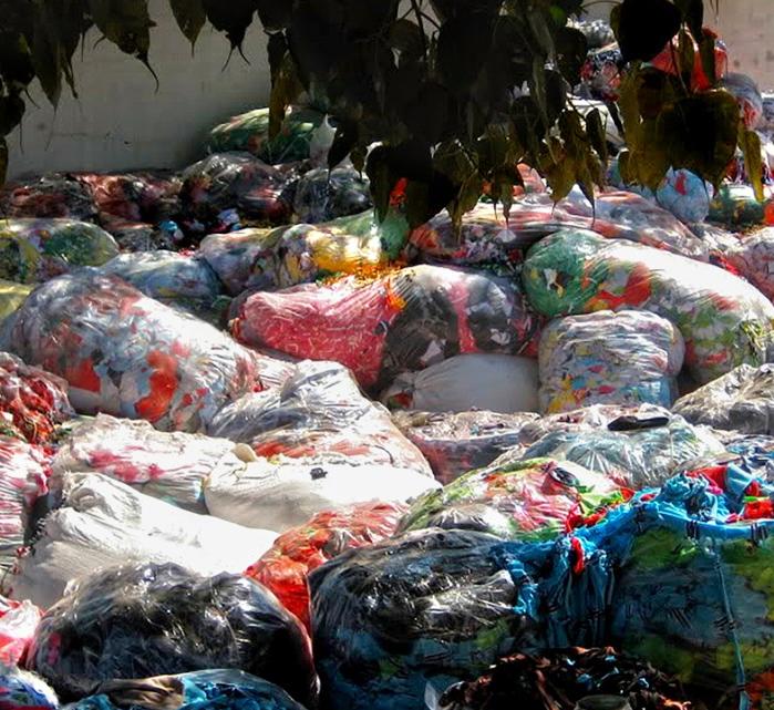 stock image of garbage bags full of textiles
