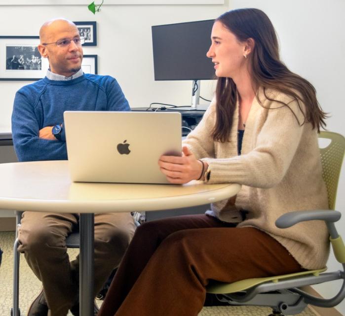 Anthony Burrow, center, the Ferris Family Associate Professor of Life Course Studies in the College of Human Ecology, discusses research with Lynandrea Mejia, left, of the Bronfenbrenner Center for Translational Research, and Ravenel Davis, a doctoral student.
