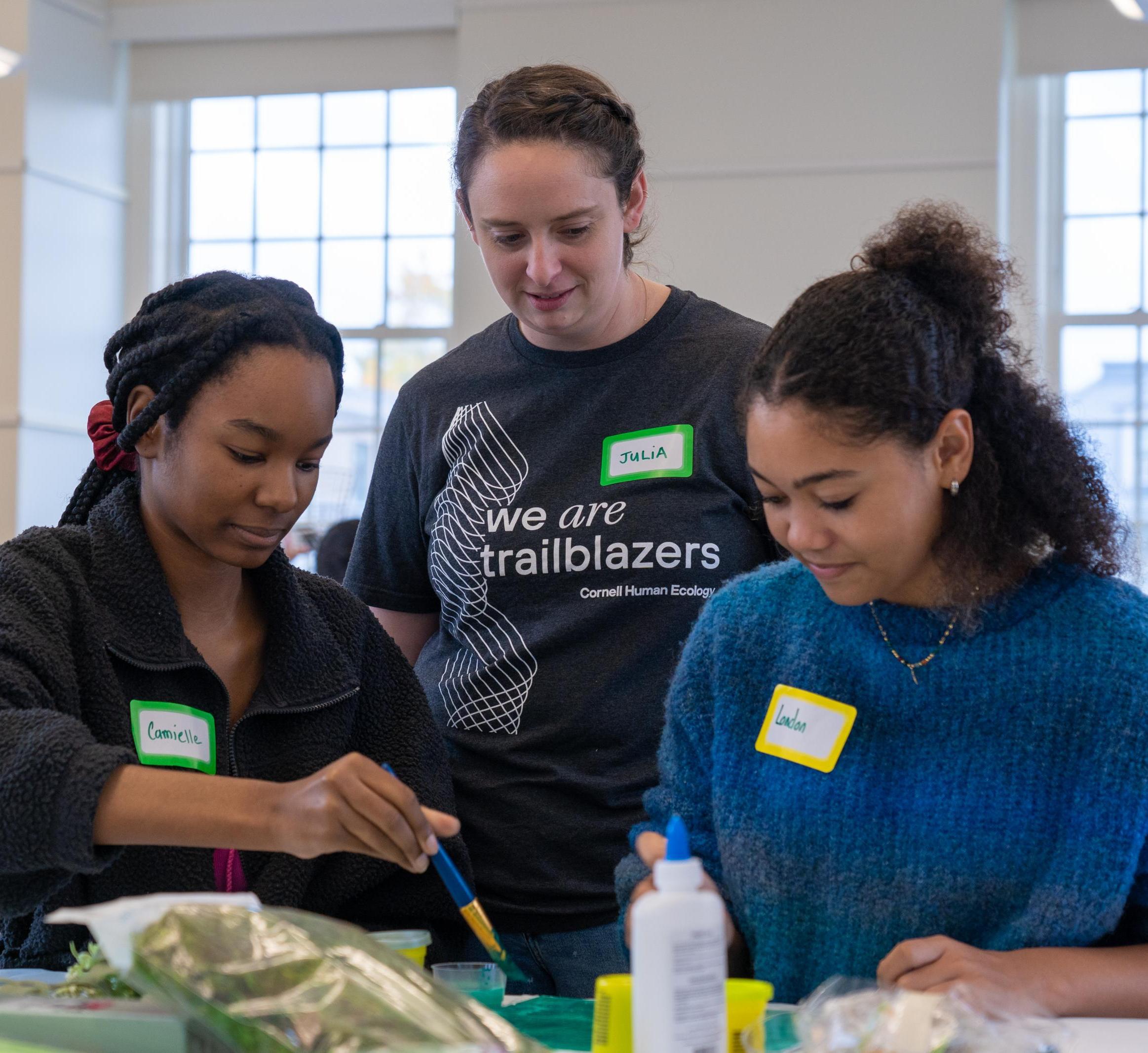 Two youth create their vision for an ideal outdoor space as Julia Jaffe looks on