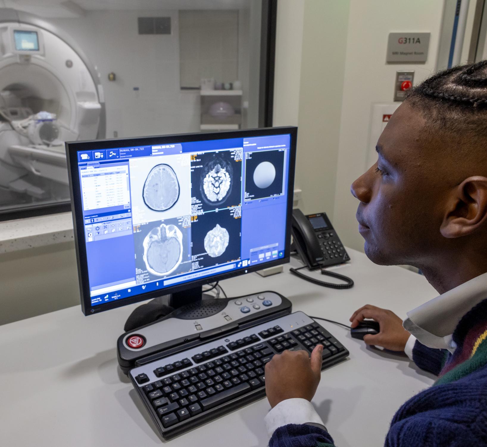 Senegal Mabry looks at brain MRIs