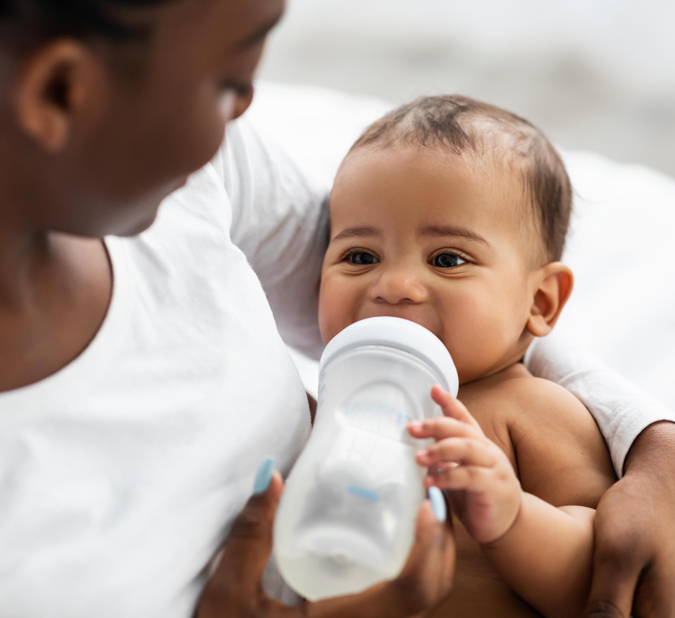 Woman feeding a baby a bottle