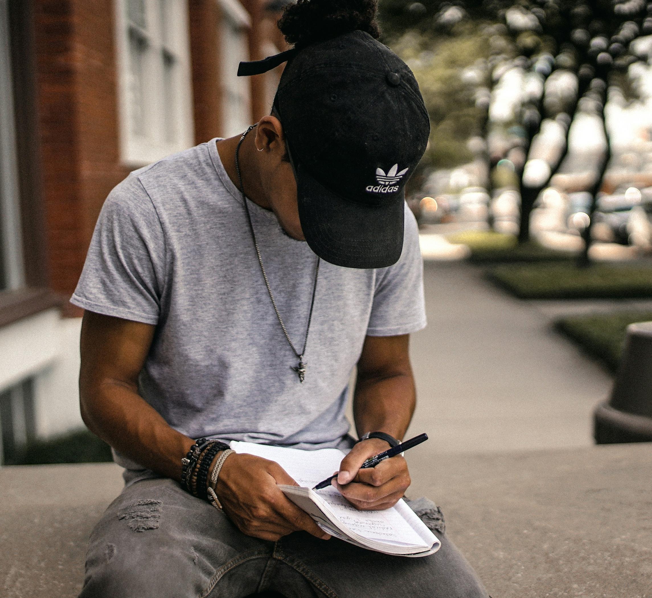 Teenager writing in a notebook 