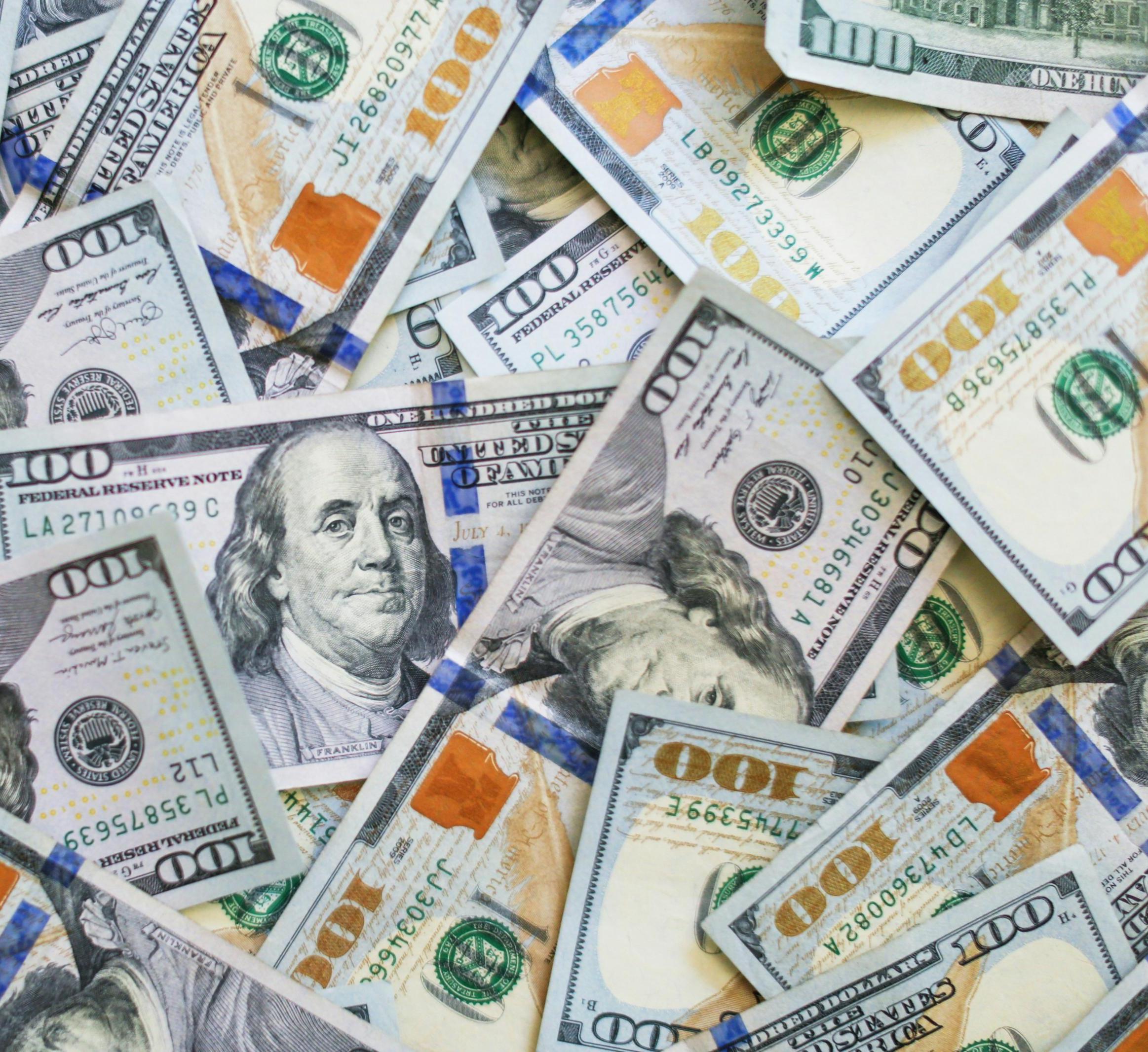 US $100 bills in different orientations 