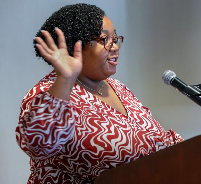 Misha Innis-Thompson speaks to a crowd in the Statler Ballroom