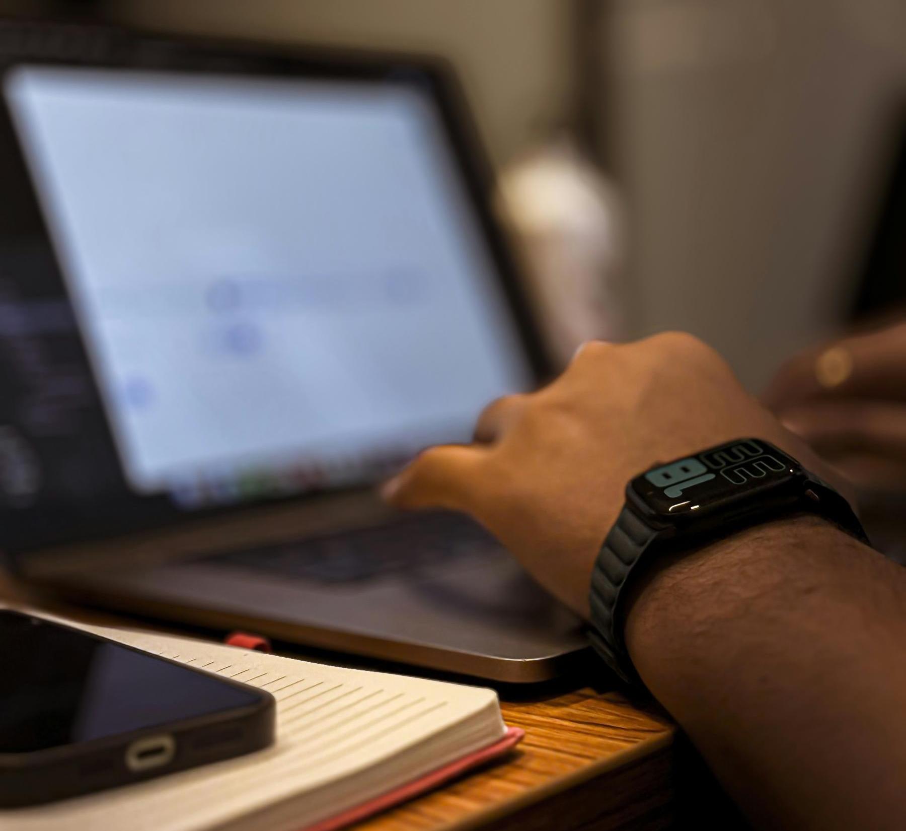 Person typing at a laptop