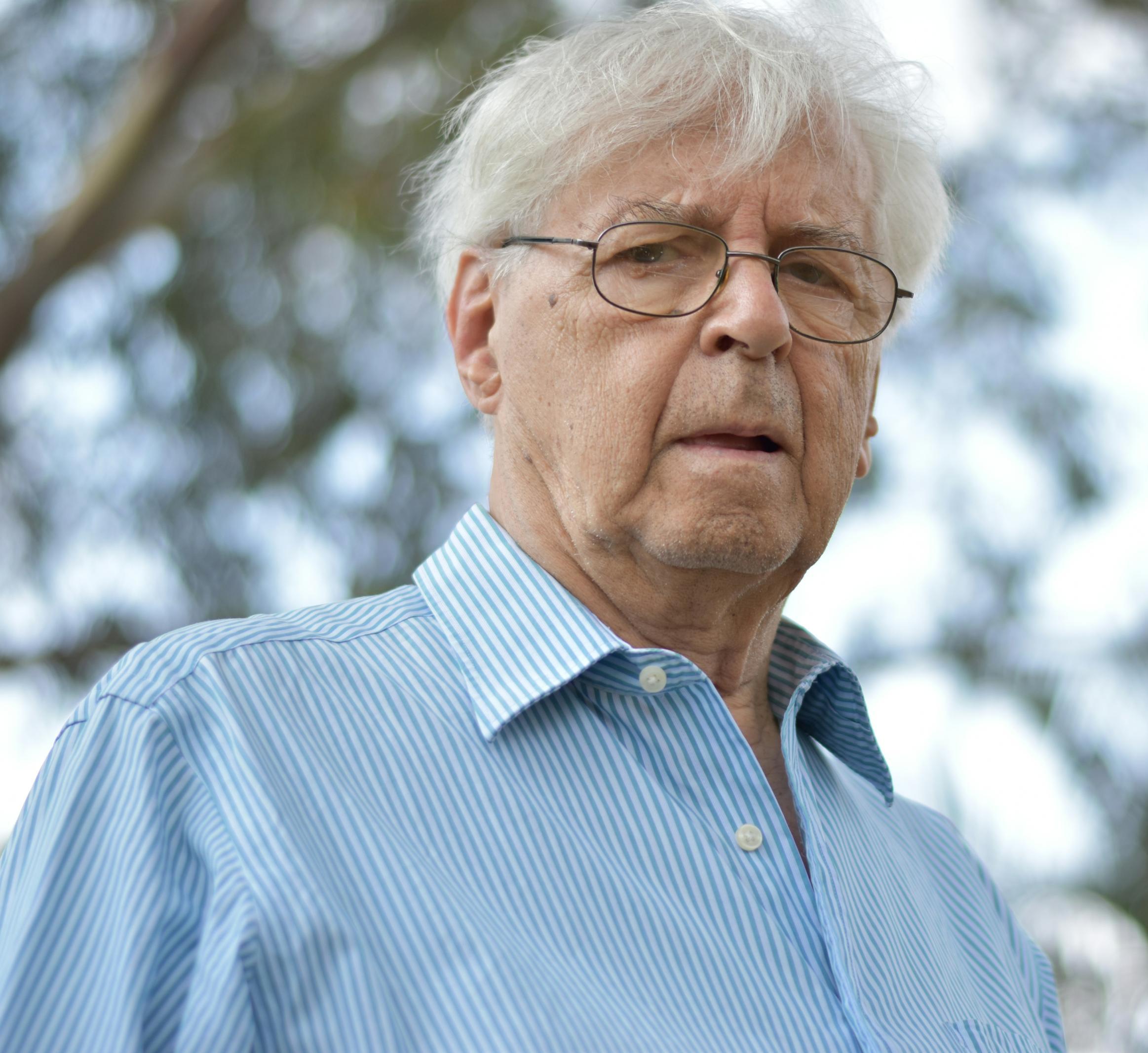 Older man looks seriously at the camera 