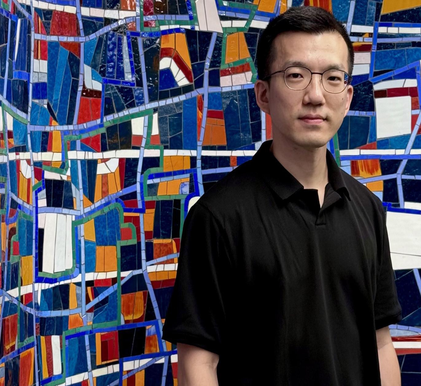 Eddy Man Kim in front of Mosaic 