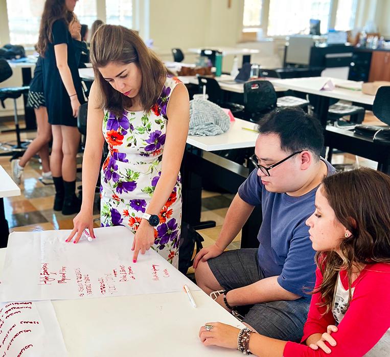 Rana Zadeh (left) consults with students in a class