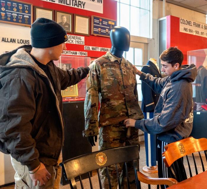 ROTC cadets adjust uniforms during preparation for the “Fit for Duty: Form and Function in Military Dress” exhibition.