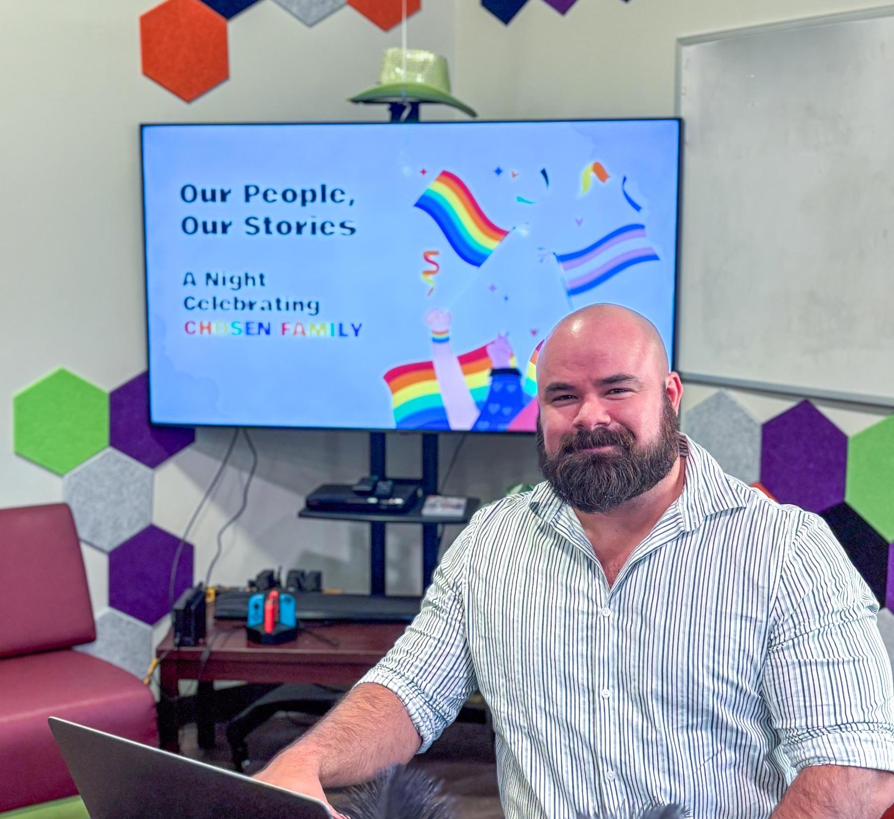 Adam Hoffman in front of a screen