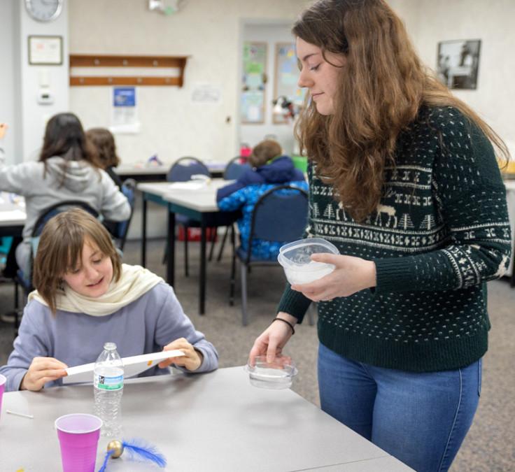 Gabrielle Dion, 4-H CARE wellness educator at Cornell Cooperative Extension Jefferson County, leads a group of students in a STEM activity