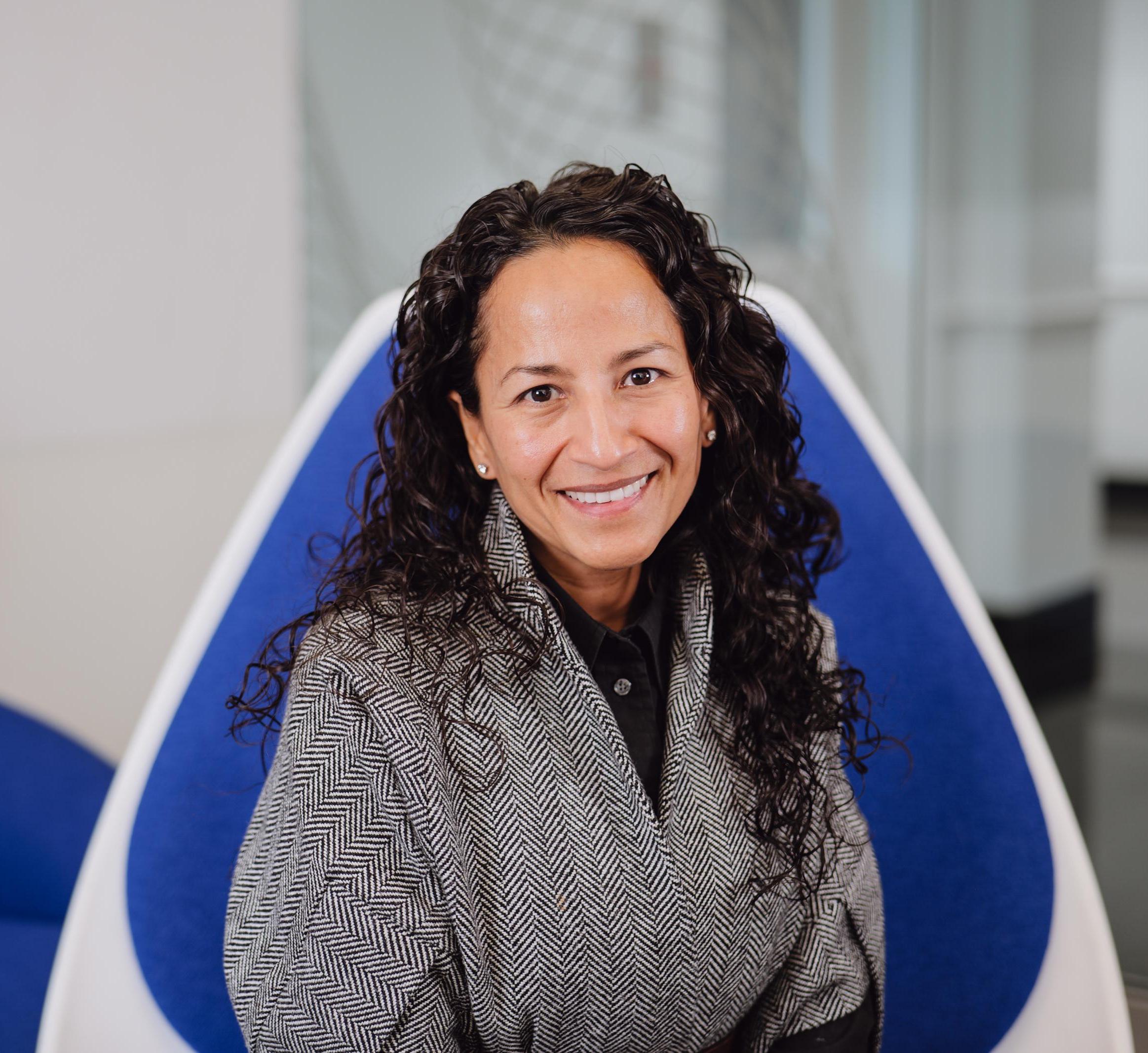 Portrait of Marla Lujan sitting in a blue chair