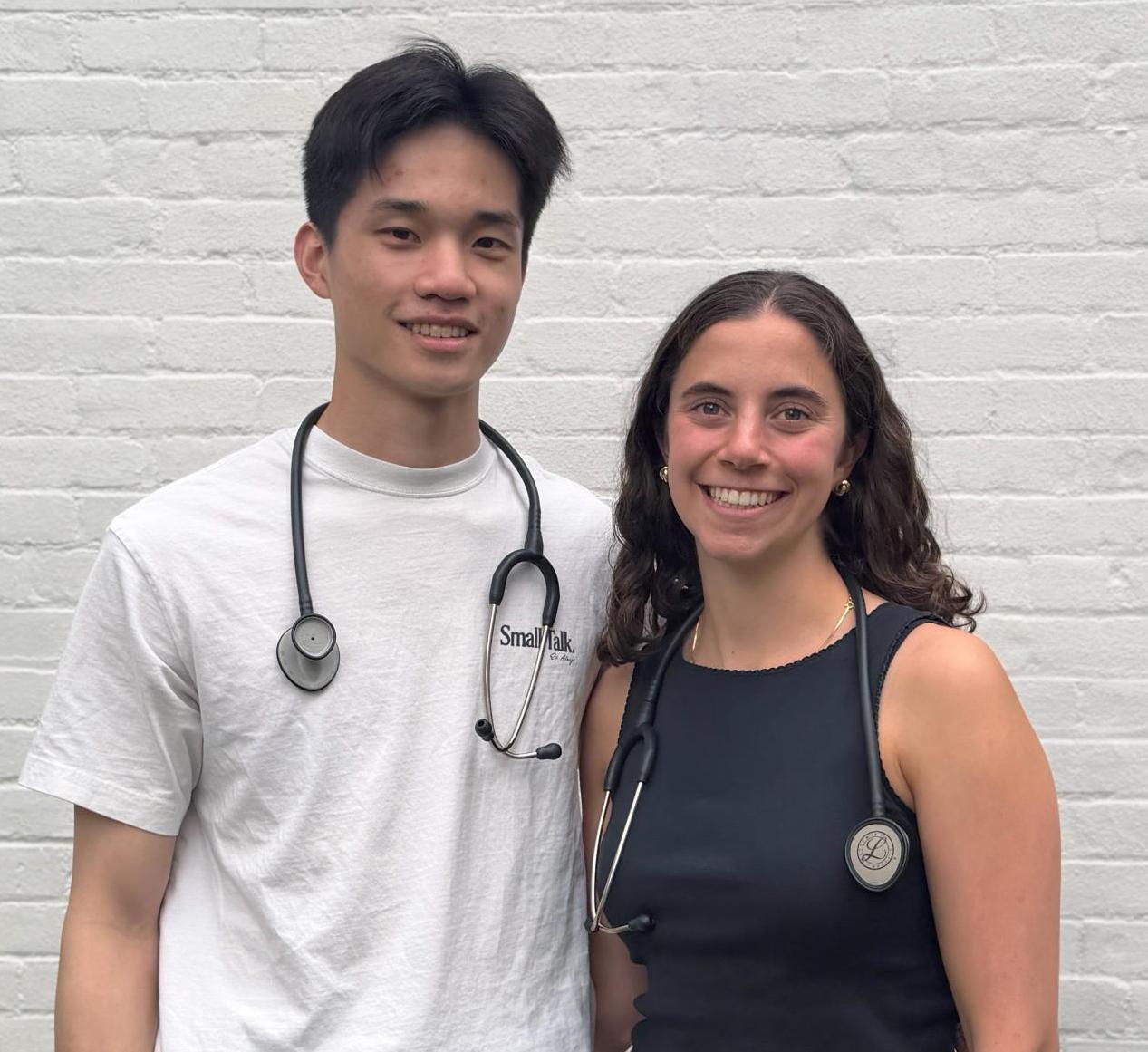 Two students post together with stethoscopes around their necks