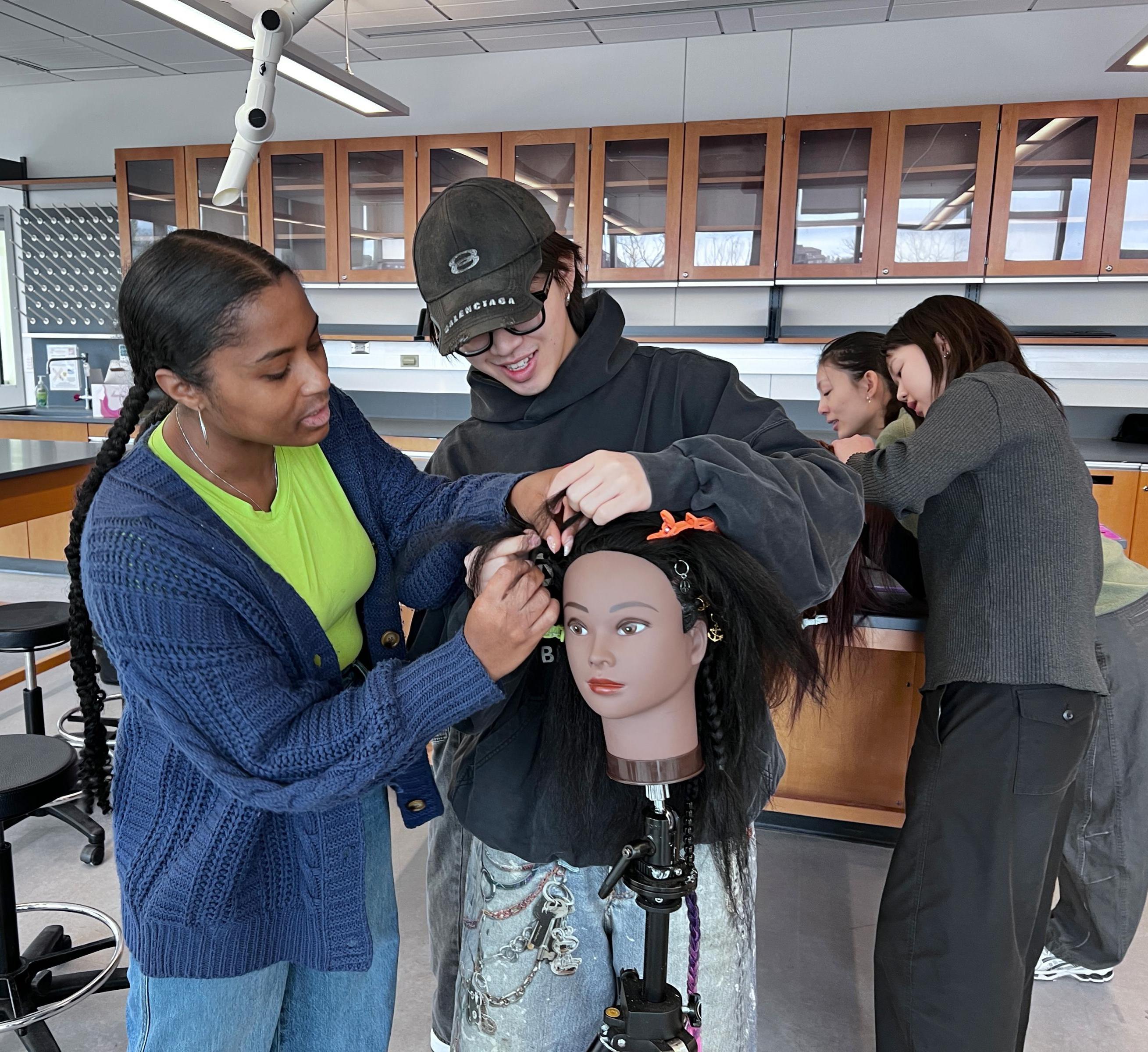 Lauren and Reto weave together braids