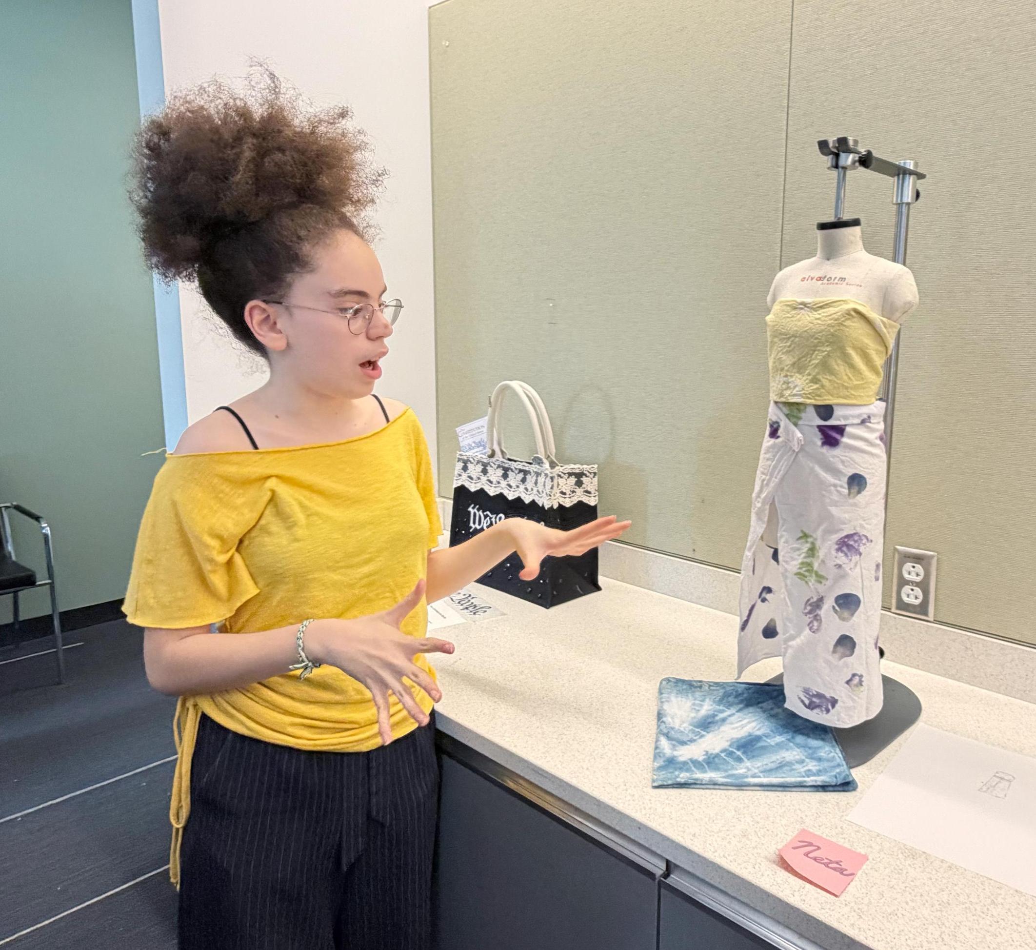 Neta explains her design work to onlookers