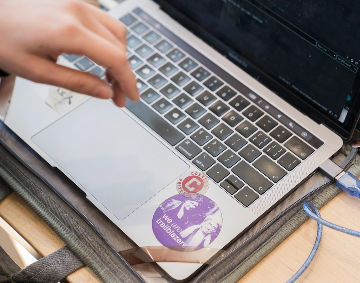 overhead view of hands with a laptop keyboard