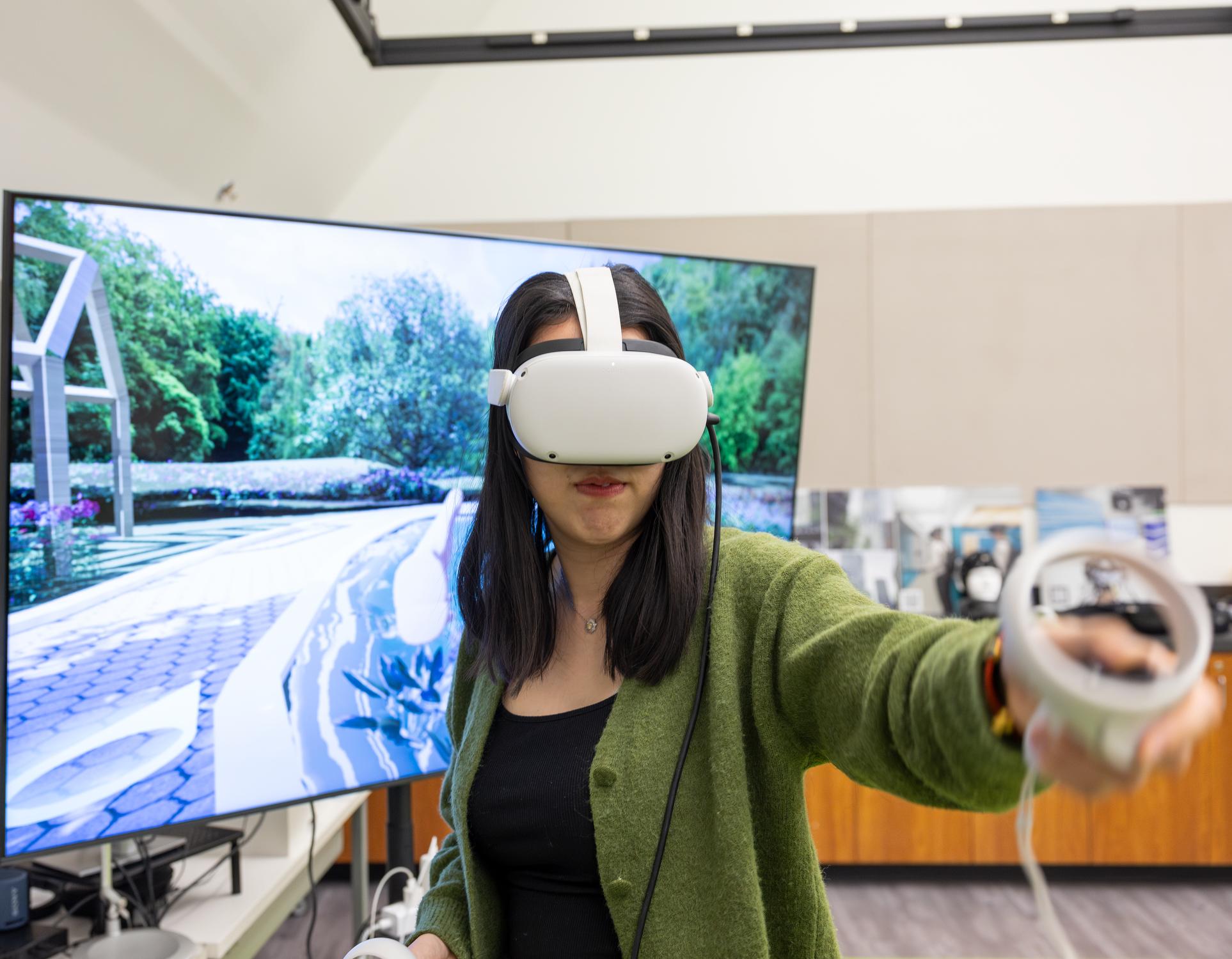 A person uses a VR headset to navigate a virtual garden.