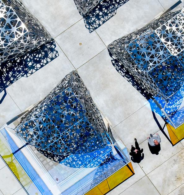 overhead view of a large sculpture with people walking