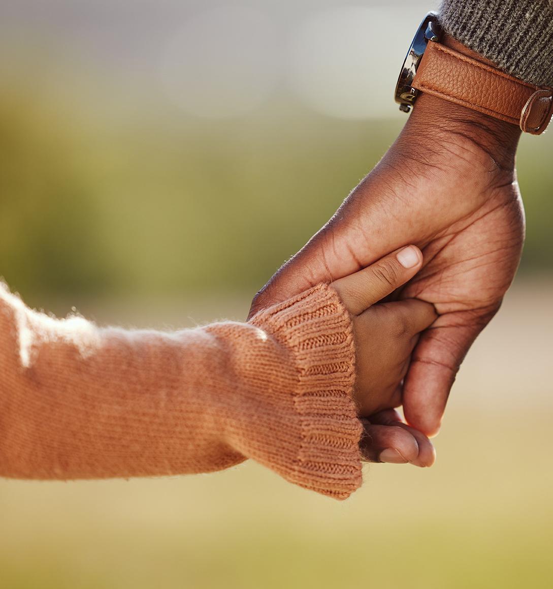 Parent holding hand of child