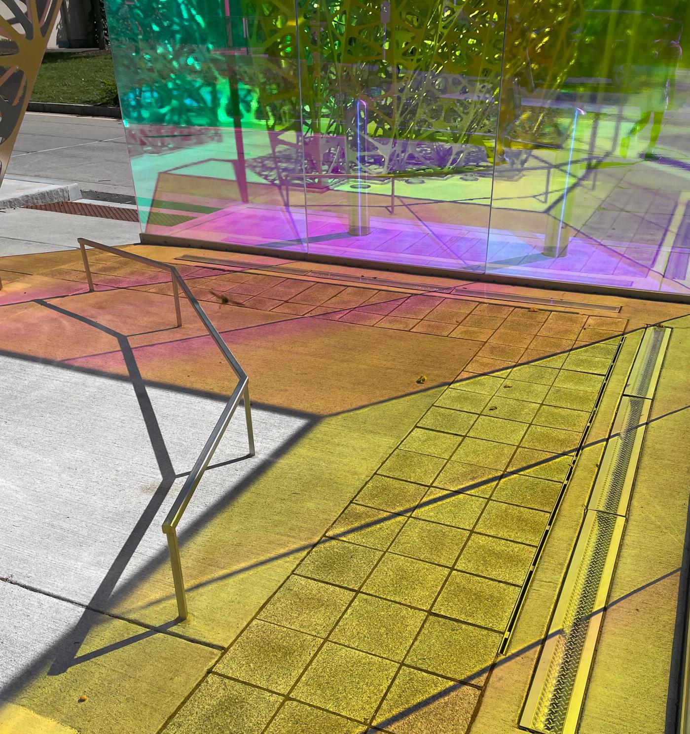 abstract pink and yellow colored shadow on a sidewalk