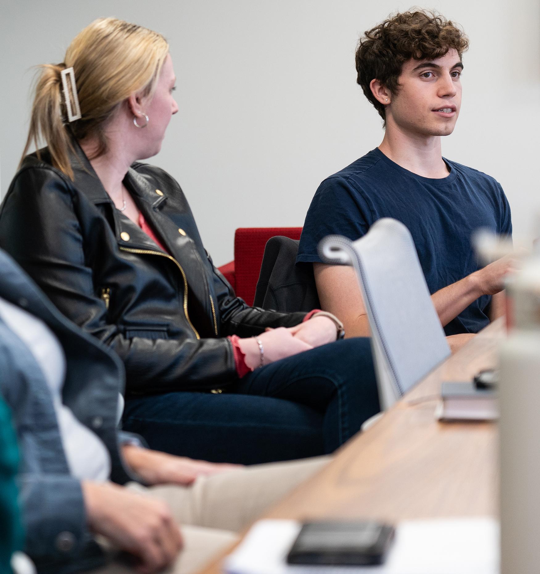 college students talking at a conference table