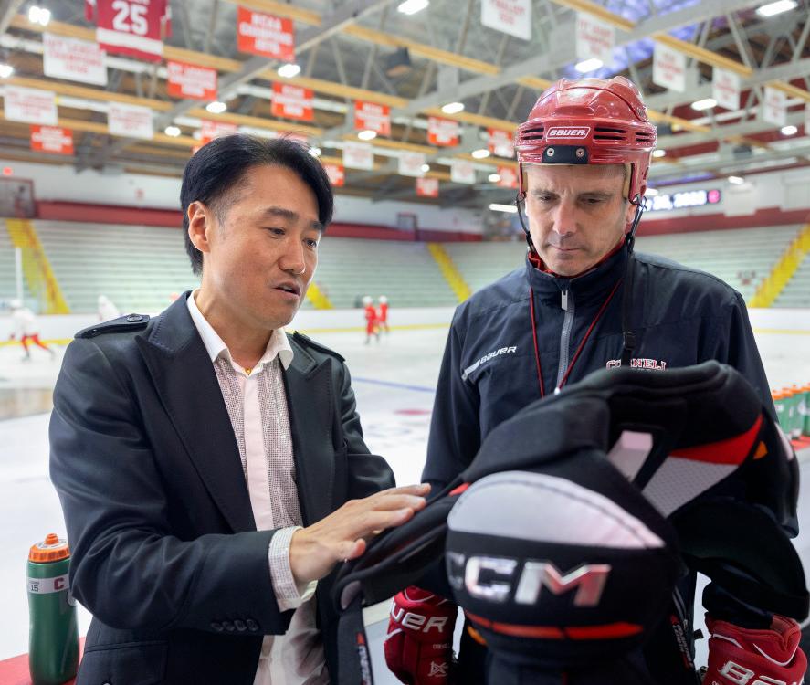 two people looking at protective gear in a hockey rink