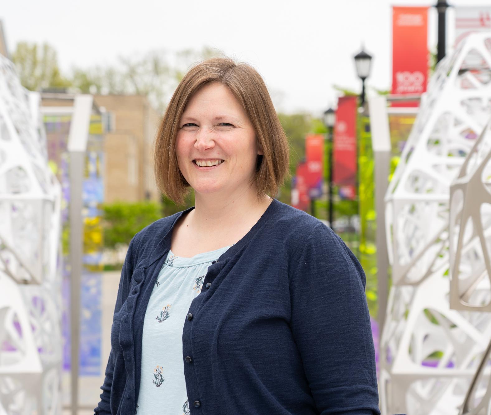 Alexa Maille stands in the Polyform outside Martha Van Rensselar Hall at Cornell.