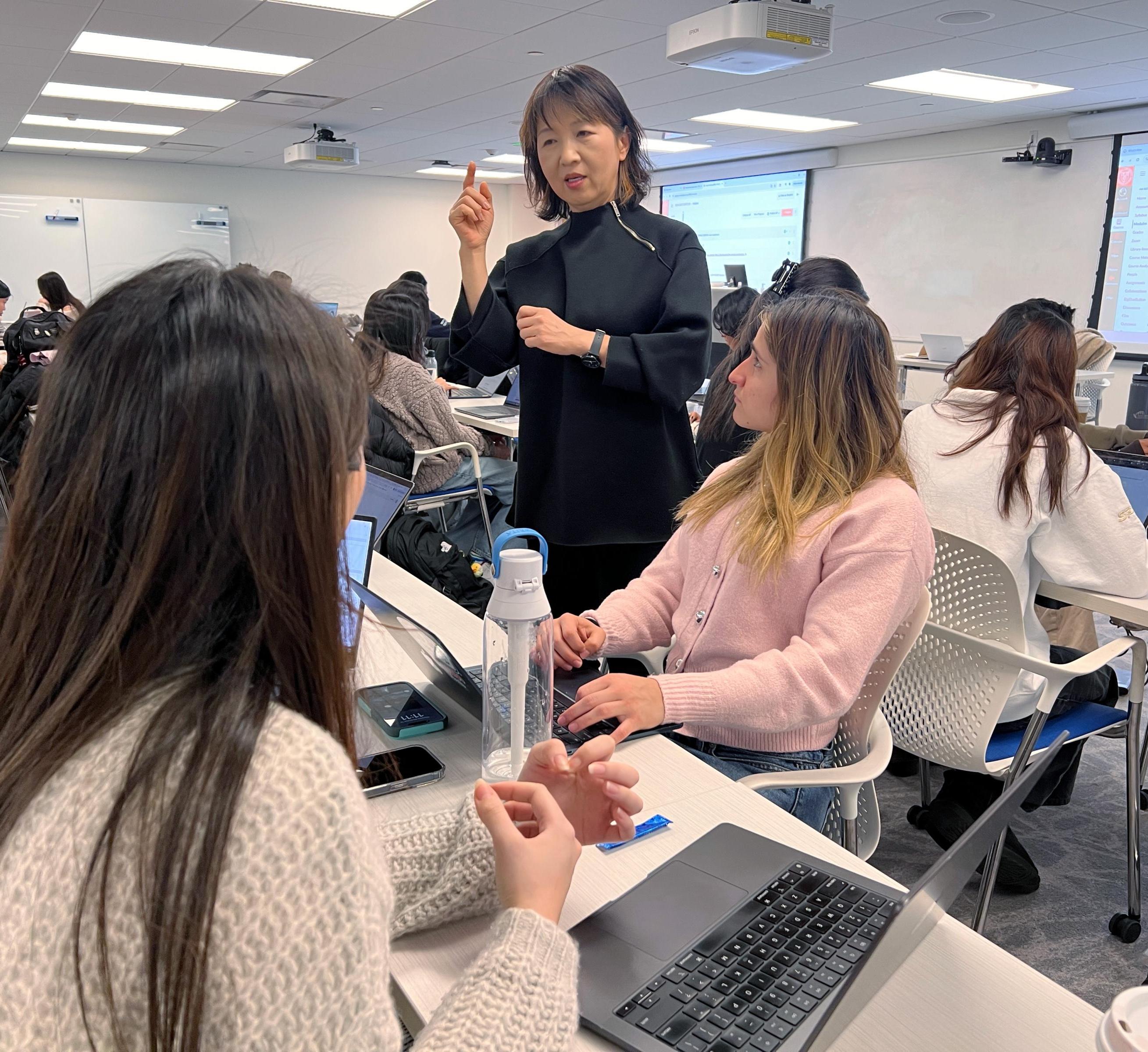 So-Yeon works with students during design time in class