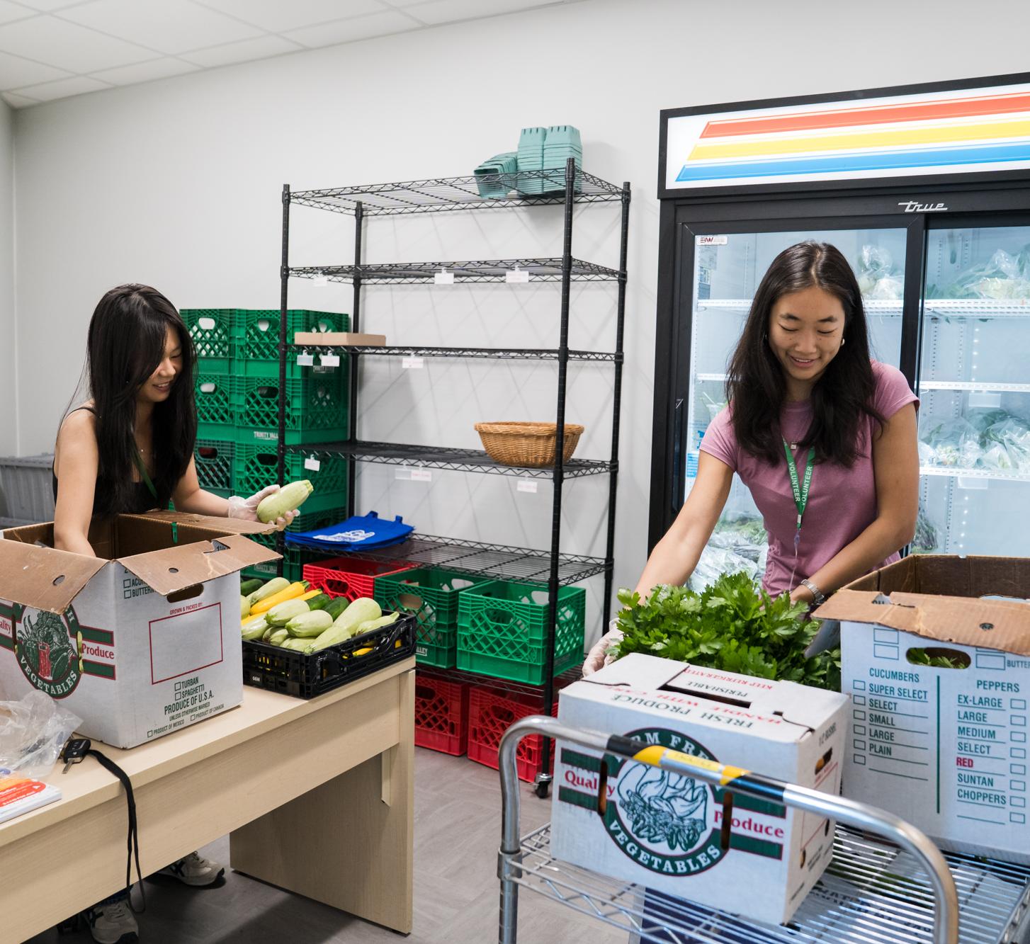 Two students help pack boxes