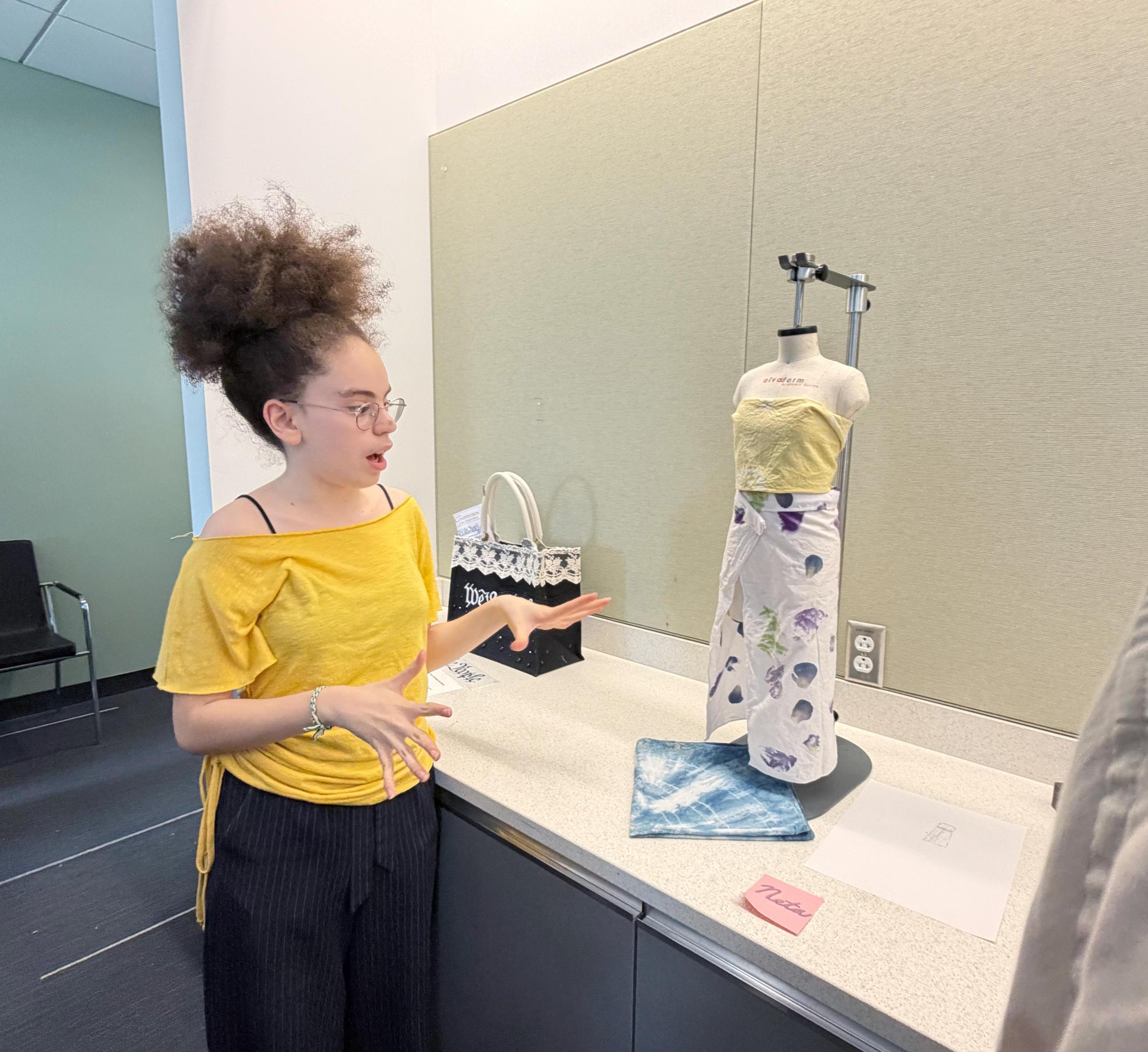 Neta explains her design work to onlookers