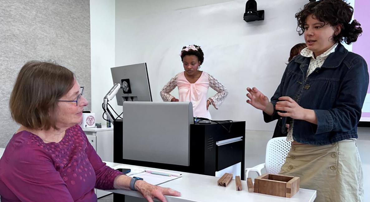 A student explaining a project to a professor.
