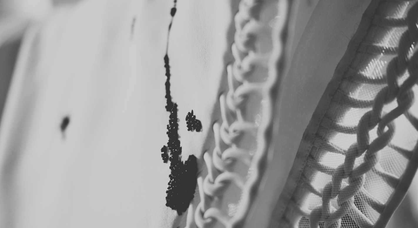 Black and white image of beads on a white gown