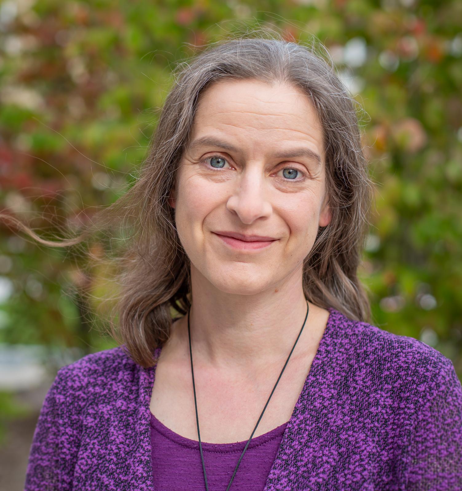 A photo of Corinna Loeckenhoff with trees in the background