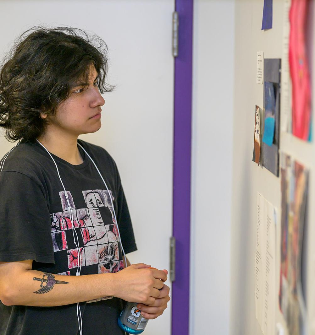 person views artwork on display