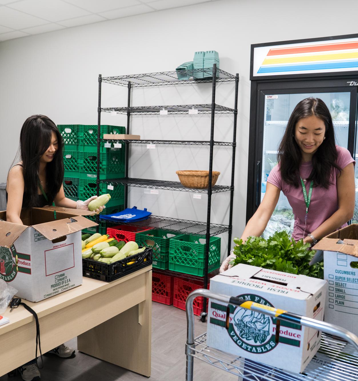 Two students help pack boxes