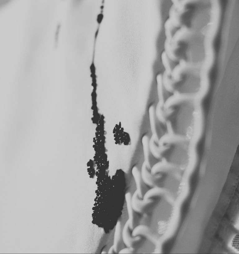 Black and white image of beads on a white gown