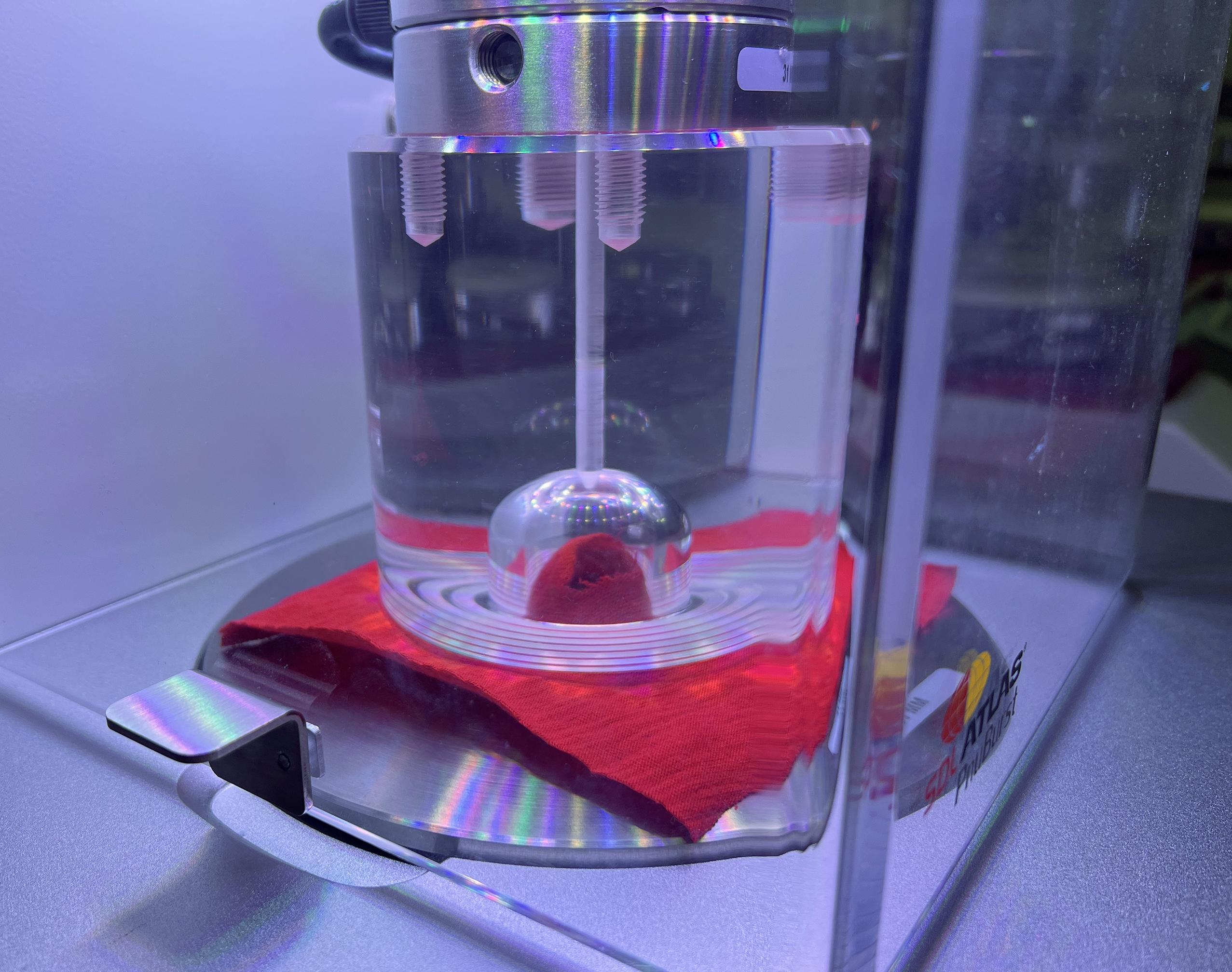 machinery performing a fabric strength test